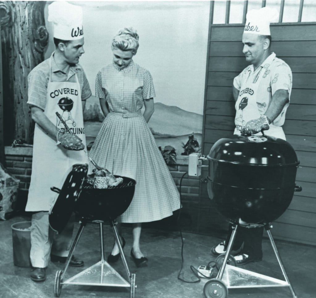 Black and white photo of 3 people grilling