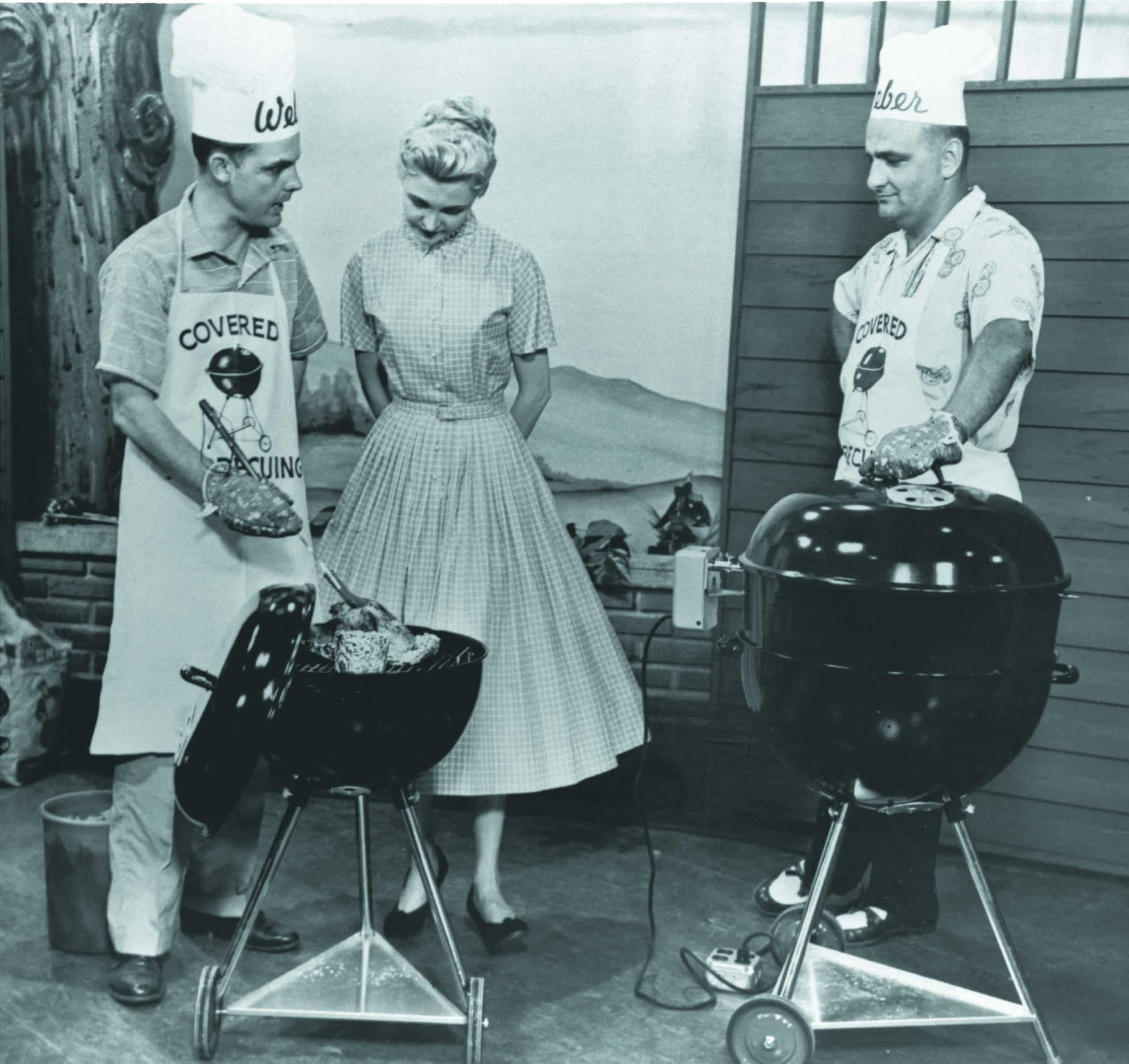 Black and white photo of 3 people grilling