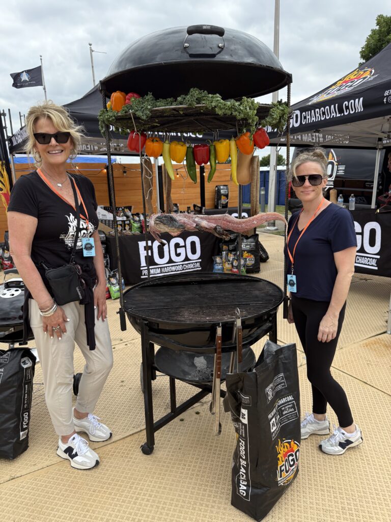 Two people with a grill outside