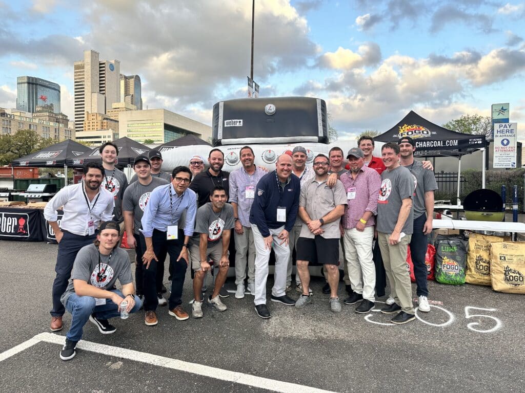 Group photo in front of Weber grill inflatable